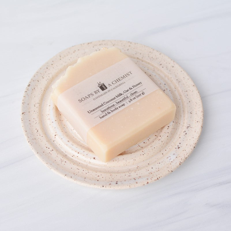cream white round speckled ceramic soap dish with soap