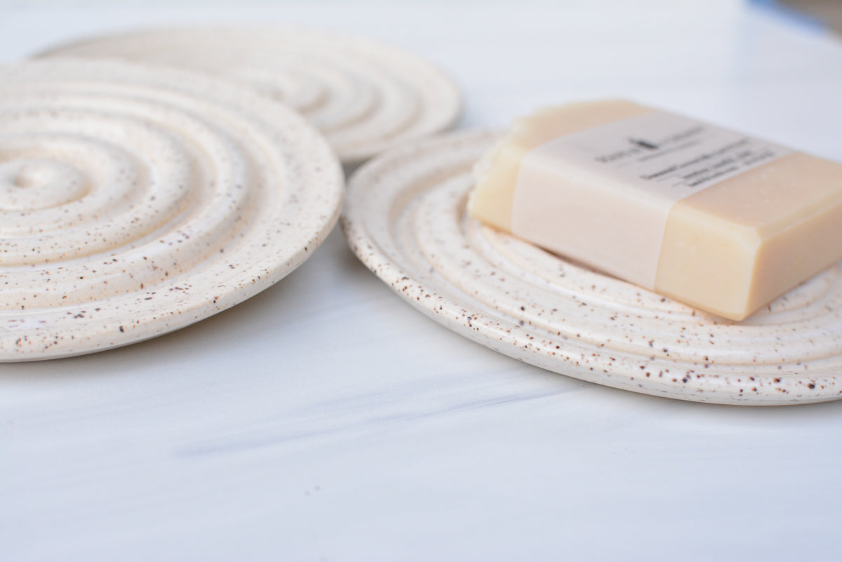 cream white round speckled ceramic soap dish side view
