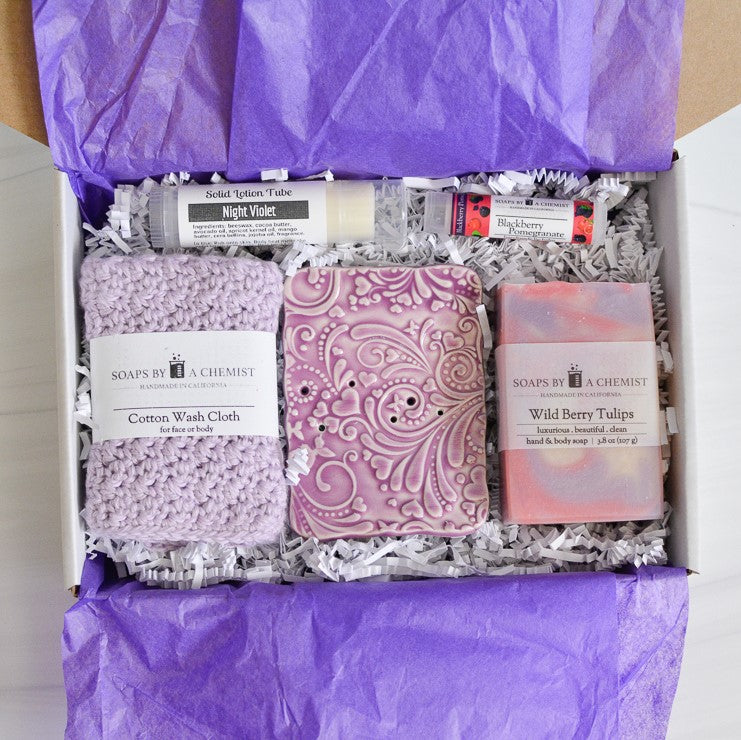 purple mother's day gift set with handmade ocean soap, ceramic soap dish, cotton crocheted wash cloth, lip balm, and solid lotion tube.