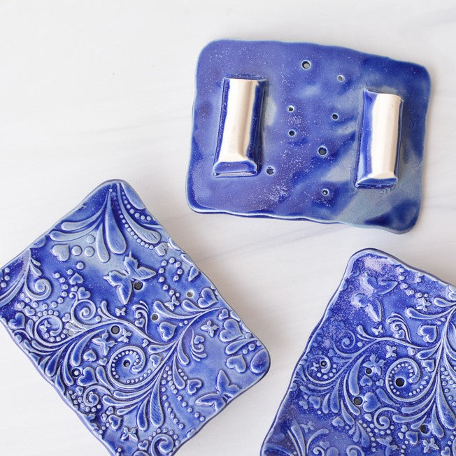 blue ceramic soap dishes made by bleu dog beads, upside down to show feet